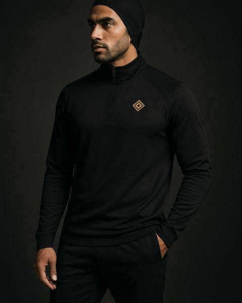 Modest quarter-zip with gold collar mark and tapered jogger